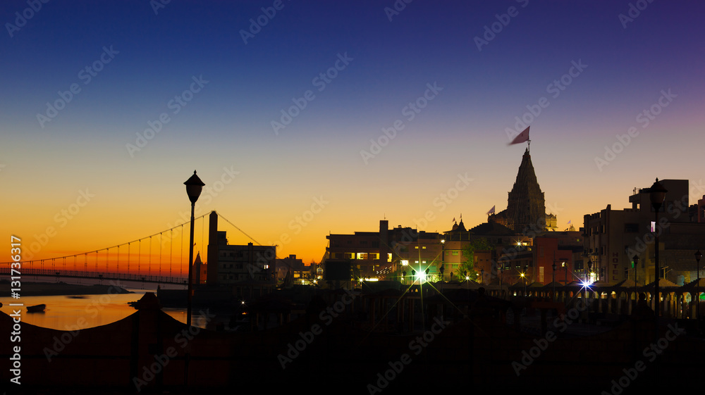 Fototapeta premium View of Gomti river and Krishna Temple Shree Dwarkadhish at night. Dwarka, Gujarat, India