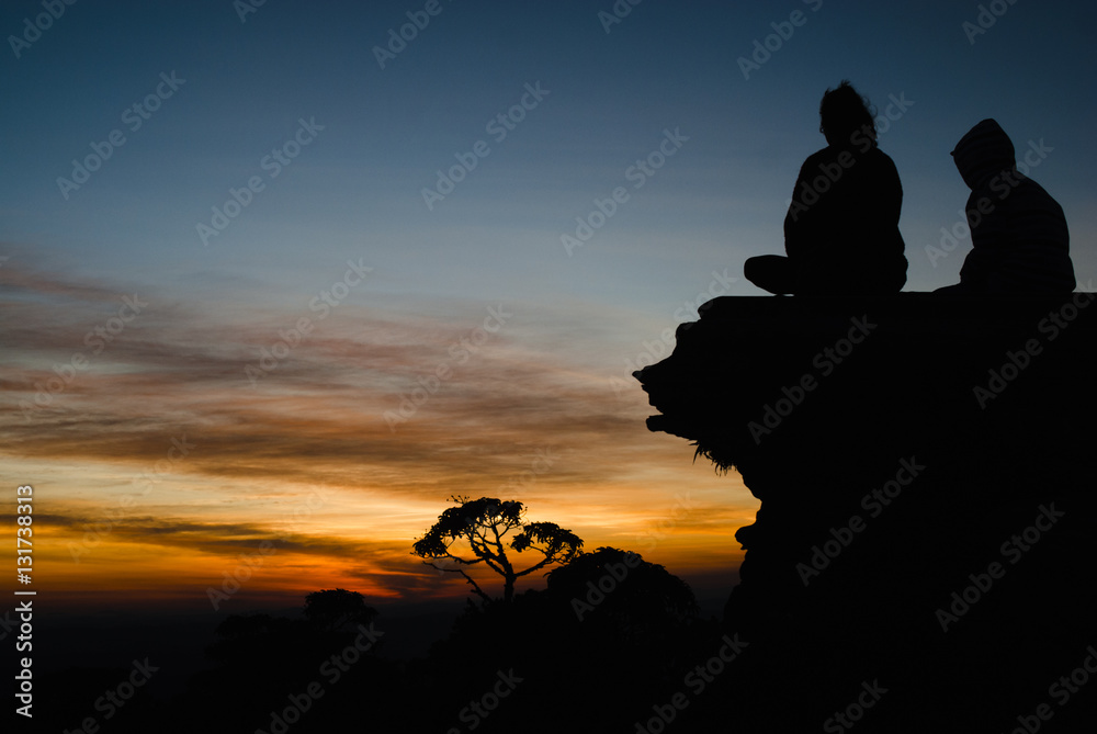 Couple, stones and trees silhouettes at sunrise in Brazil