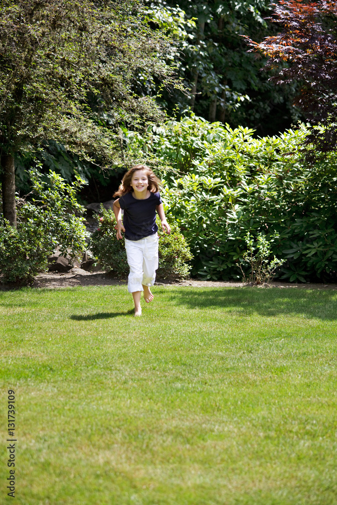 Young girl runs across the grass to get an afternoon snack