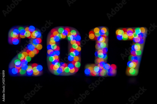 Abstract 2017 message in colorful bokeh lights on black background