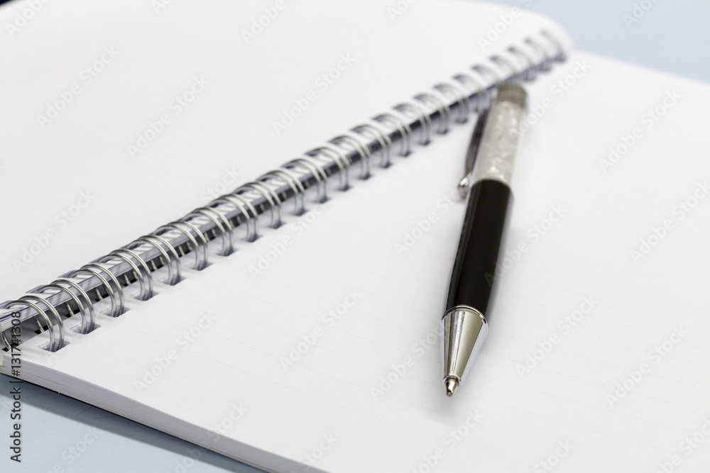 Black pen and notebook on the desk. Black pen and notebook on the desk.