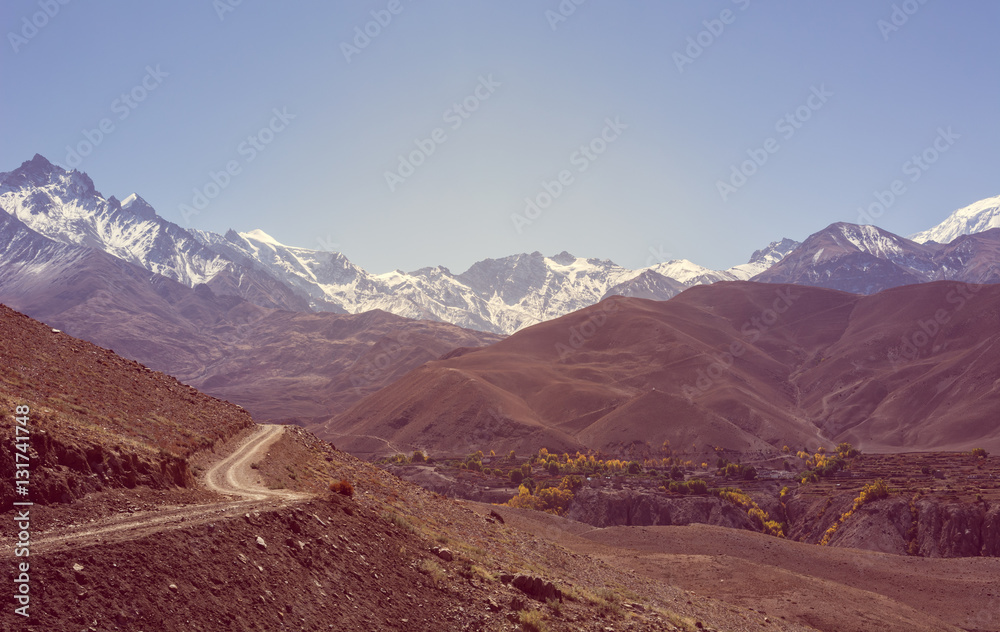 Mountain landscape with road running through wasteland.