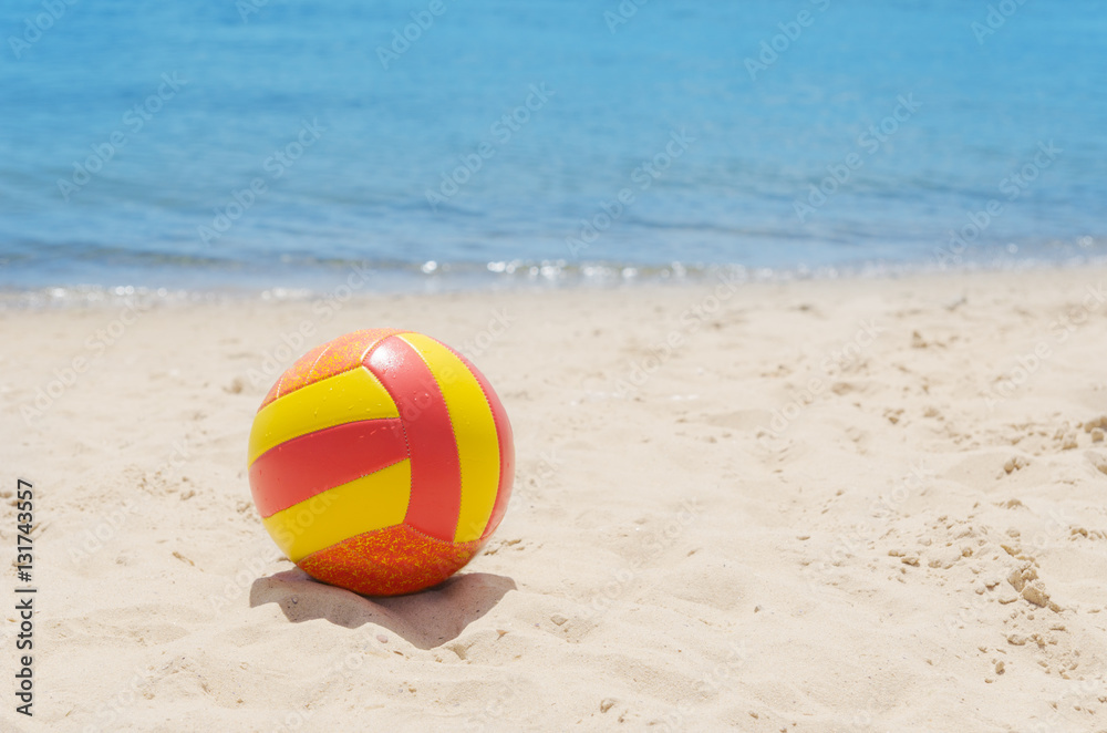 color ball on sand near sea