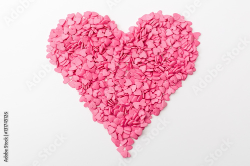 pink heart made of many smaller hearts on a white background. festive background for Valentine's day, birthday, holiday