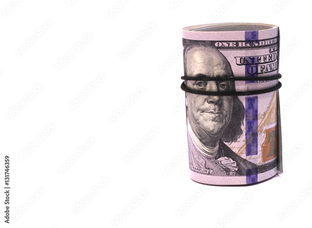 Money. Rolled into a tube of one hundred dollars banknotes Money. Rolled into a tube of one hundred dollars banknotes