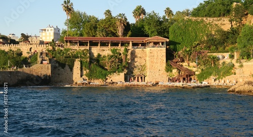 Fototapeta Naklejka Na Ścianę i Meble -  Mermerli Beach and Restaurant with the City Walls in Antalyas Oldtown Kaleici, Turkey