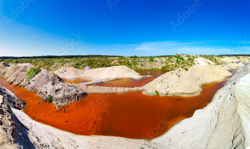 sand quarry filled with water saturated minerals photo