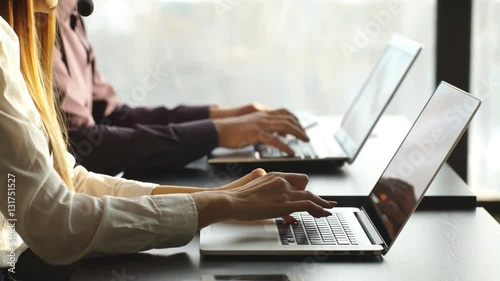 a man and a woman working at a computer in the center of the number