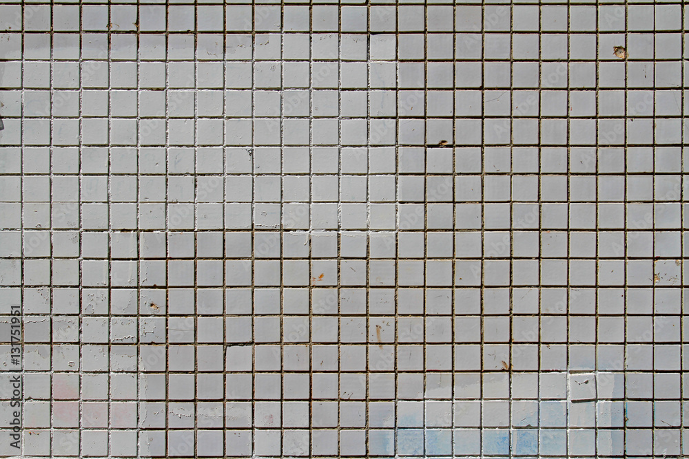 Mosaic tiles on the facade of a house. Architectural background made of grey mosaic wall Mosaic tiles on the facade of a house. Architectural background made of grey mosaic wall
