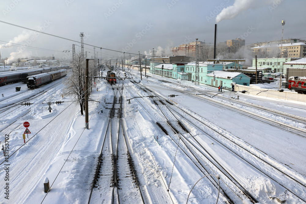 Railway in a winter day and snow around