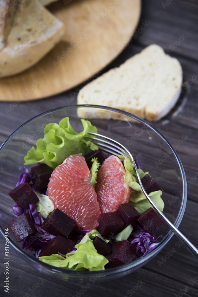 salad with grapefruit, red cabbage, beets and lettuce. bread
