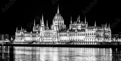 Photography Night view of illuminated historical building of Hungarian Parliament, aka Orszaghaz, with typical symmetrical architecture and central dome on Danube River embankment in Budapest, Hungary, Europe