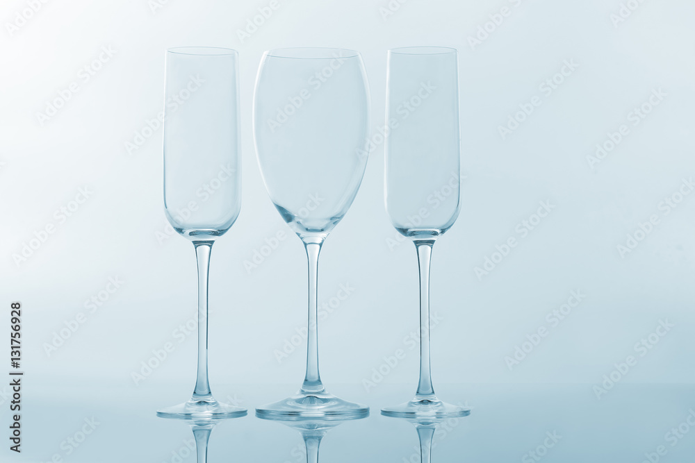 three empty wine glass on a light background three empty wine glass on a light background