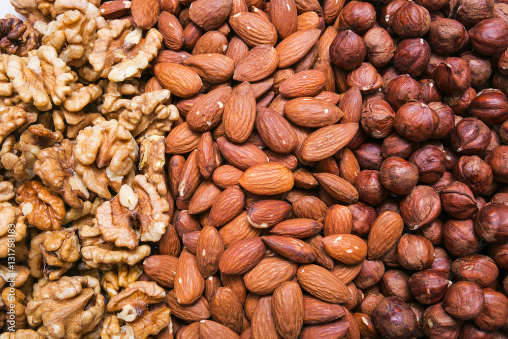 Peeled almonds, hazelnuts and walnuts kernel background or textu Peeled almonds, hazelnuts and walnuts kernel background or textu