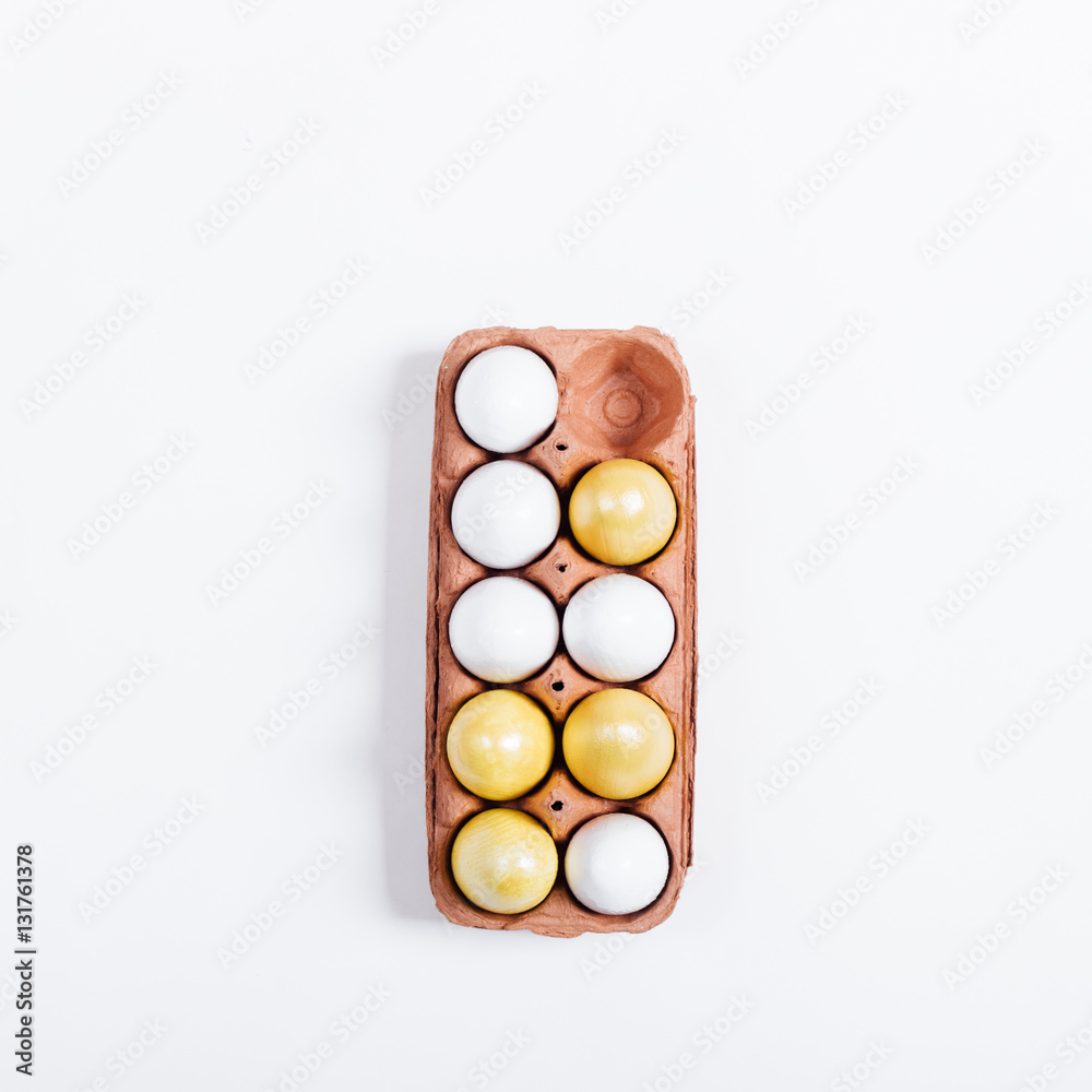 Tray of yellow Easter eggs on white background Tray of yellow Easter eggs on white background