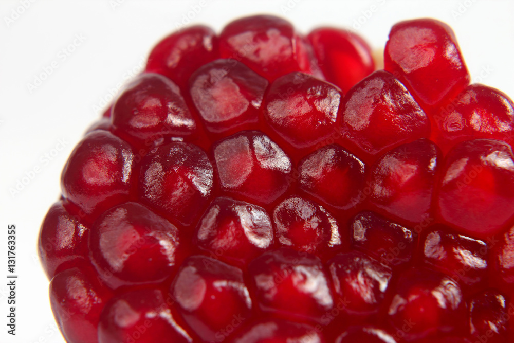 peeled pomegranate fruit closeup on white background peeled pomegranate fruit closeup on white background