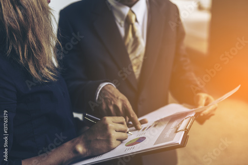 close up business women hand holding spectacles in office morning light. photo