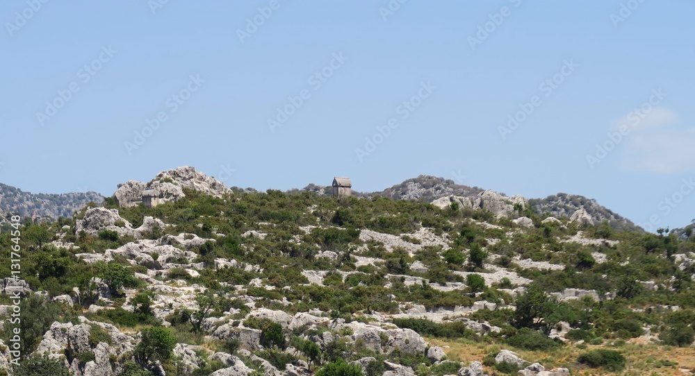 Fototapeta premium Lykian Rock Tombs at the Ruins of the Sunken City Simena near Kekova Island, Turkey
