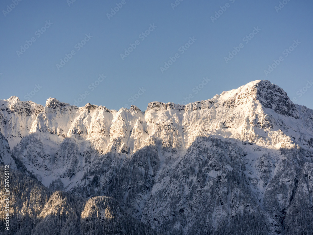 Blue Sky Background for Snowy Mountain Ridgeline with Shadow and Sun Light Contrast
