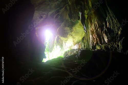 Cave with sunlight glare passing through © razihusin