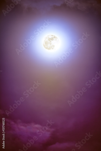 Nighttime sky with clouds and bright full moon with shiny. © kdshutterman