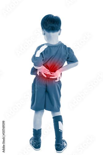 Obraz na płótnie Back pain. Child rubbing the muscles of his lower back. Isolated on white background. w salonie
