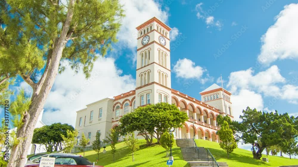 The Bermudan Parliament Building in the City of Hamilton, Bermuda. Featuring Vibrant Colors in Green Trees, Grass and White Clouds in a Blue Sky Background on a Sunny Day