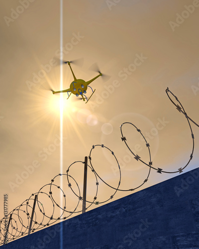 3D illustration of a UAV drone patrolling along a concrete wall with barbed wire. Fictitious drone, motion blur for dramatic effect.