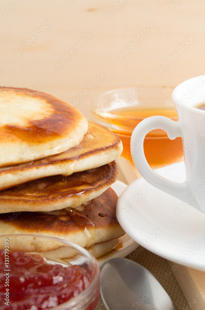 Pancake with honey and jam and white cup of tea Pancake with honey and jam and white cup of tea
