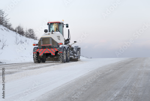 machine cleans snow from the road © ezumer