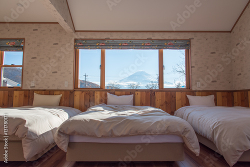 фотографія Bed with MT.Fuji view as background outside the window in winter