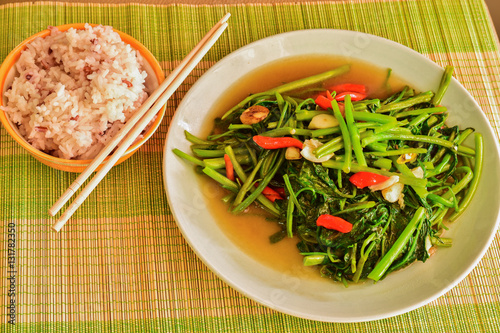 Stir fried morning glory vegetable with mixed white and brown rice, Thai Food in Asian.