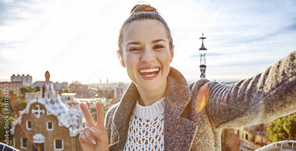 Fototapeta premium happy trendy tourist woman in Barcelona, Spain taking selfie