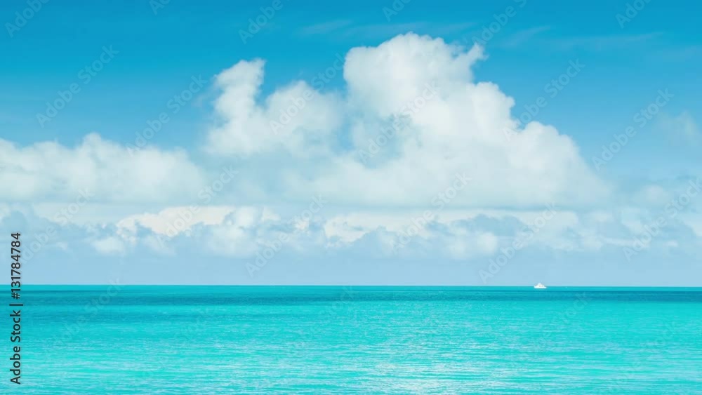 Little White Boat on Vast Tropical Ocean Waters in Bermuda with a Blue Sky Full of White Clouds on a Sunny Day Little White Boat on Vast Tropical Ocean Waters in Bermuda with a Blue Sky Full of White Clouds on a Sunny Day
