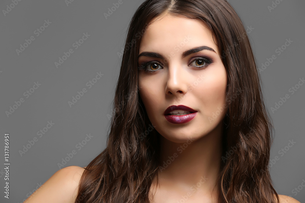 Portrait of beautiful young woman model with bright makeup on dark background Portrait of beautiful young woman model with bright makeup on dark background