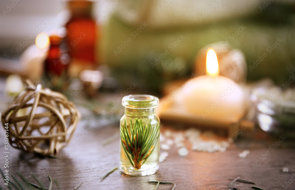 Bottle of pine essential oil on wooden table