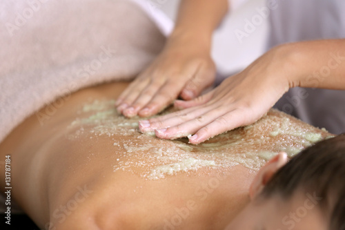 Wallpaper Mural Young woman receiving scrub massage in spa salon Torontodigital.ca