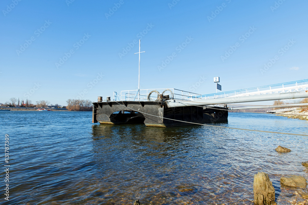 Dock on the river in winter sunlight