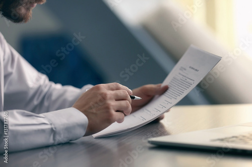 Businessman reading documents photo