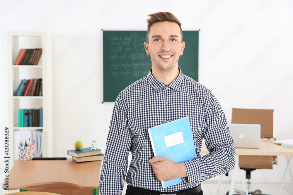 Young male teacher in classroom Young male teacher in classroom
