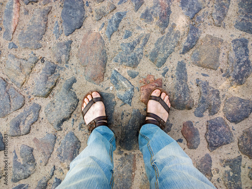 Feet on the cobblestone.