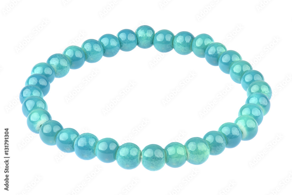 Turquoise elastic bracelet made of small pearl-like round beads, isolated on white background, clipping path included Turquoise elastic bracelet made of small pearl-like round beads, isolated on white background, clipping path included