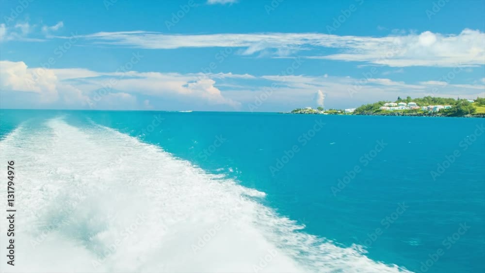 Boat Leaving a Wake Behind with Splashing White Water in the Ocean Near a Tropical Island in Bermuda on an Idyllic Day