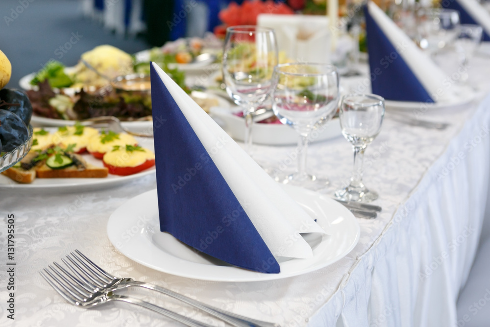 fragment of serving a festive table with blue-white napkin. Soft focus, selective focus