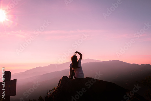 The silhouette of a woman Happy mountain morning sunrise.