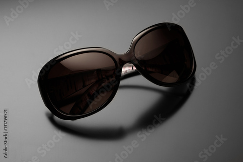 female sunglasses isolated on grey background