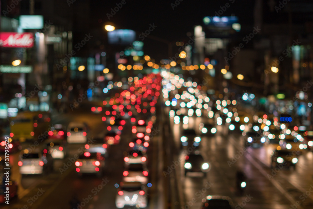 Defocused lights car traffic jam of a street road at night retro