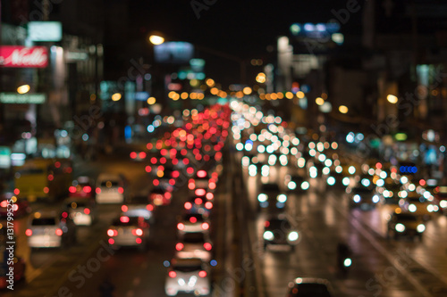 Defocused lights car traffic jam of a street road at night retro