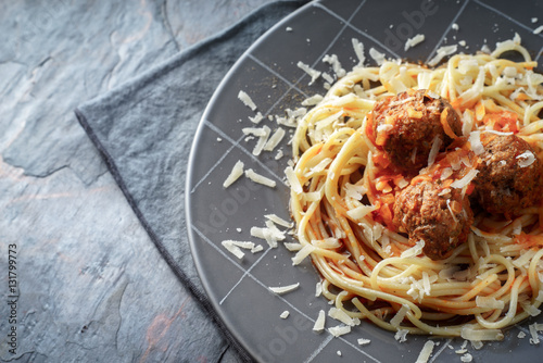 Spaghetti with meatball in the grey plate on the stone background