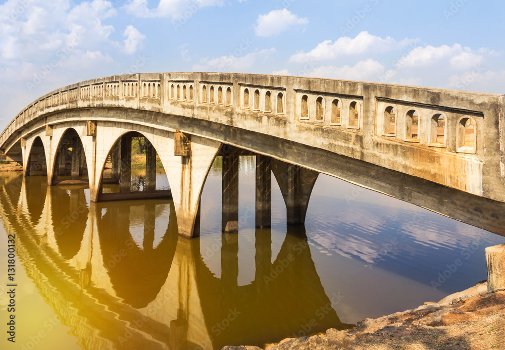 Fototapeta premium concrete arch bridge cross the canal in the park